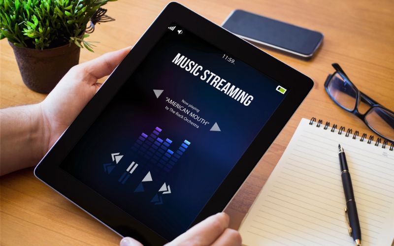 Curated music playlist on a tablet for a real estate open house event